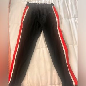 Black pants with lines in white and red